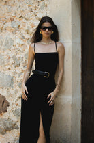 This dress features a square neckline and simple straps that crisscross in the back for a perfect fit. The split front skirt creates a tailored silhouette.