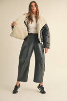 Meet your favorite new Vegan leather pants with twist! Dress them up or down, wear them with flats, heels or boots. The flattering barrel cut leg will keep you comfortable while looking ultra cool. These are a Fall must have!

Vegan leather fabric in black
Barrel leg style
Front zip and button closure
Mid rise

Side pockets
Hits at ankle
Dry Clean
True to size
Model is 5'7" and wearing a Small