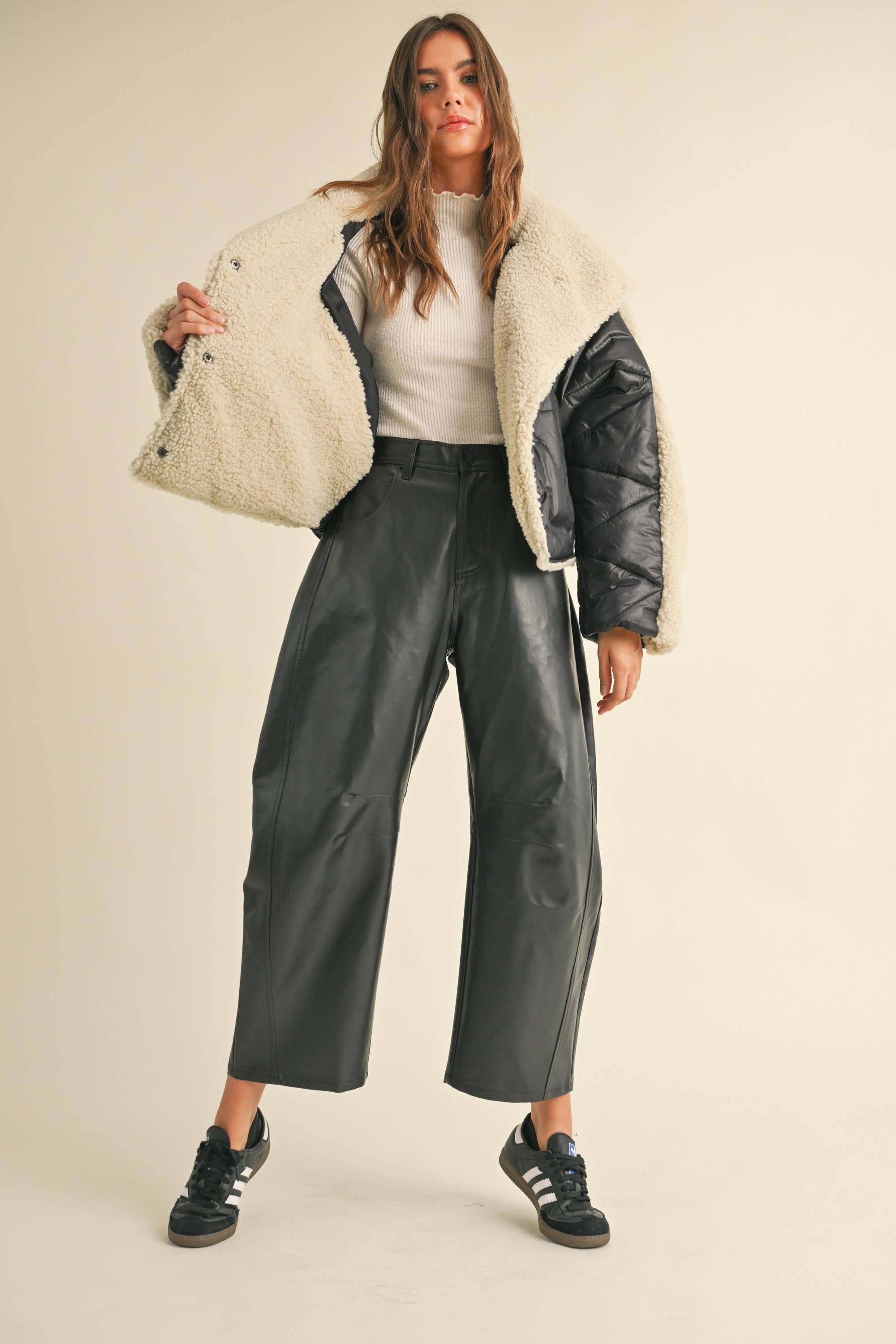 Meet your favorite new Vegan leather pants with twist! Dress them up or down, wear them with flats, heels or boots. The flattering barrel cut leg will keep you comfortable while looking ultra cool. These are a Fall must have!

Vegan leather fabric in black
Barrel leg style
Front zip and button closure
Mid rise

Side pockets
Hits at ankle
Dry Clean
True to size
Model is 5'7" and wearing a Small