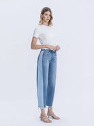Woman modeling high rise two tone raw hem barrel jeans