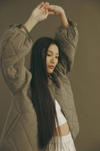 oversized button-down jacket featuring front welt pockets and drop shoulders for a relaxed silhouette. The keyhole with tie closure at the sleeves adds a touch of versatility, while the spread collars and a regular length create a modern, effortlessly chic look.